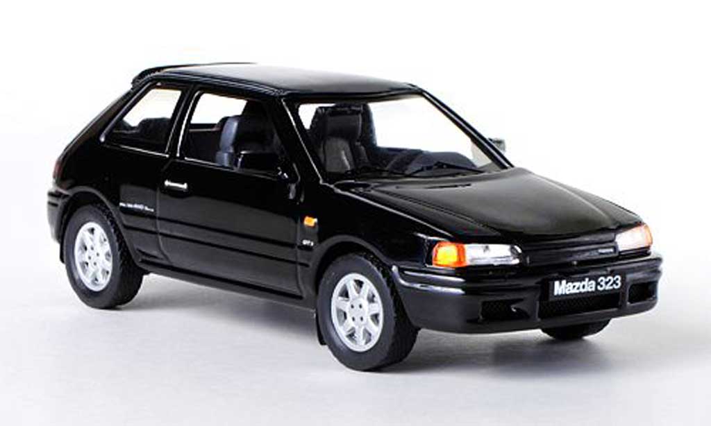 Mazda 323 1/43 IXO GTX nero LHD 1989 modellino in miniatura